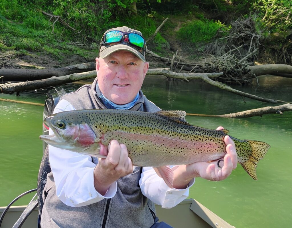 Guided angler holding a bright Rainbow Trout on the Cumberland River in Kentucky
