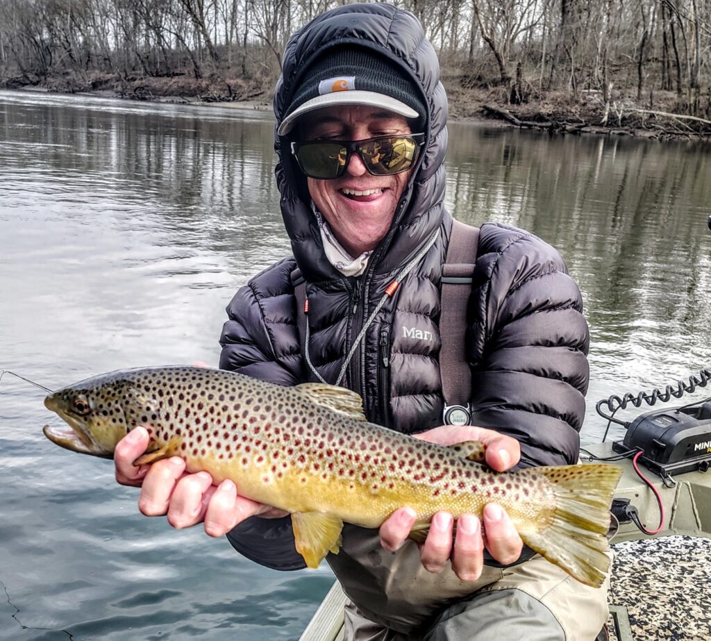 A man Holding a Brown Trout