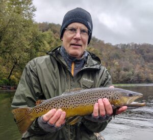 A fisherman holding a winter Brown Trout caught during a cold weather fly fishing trip on the Cumberland River in Kentucky.