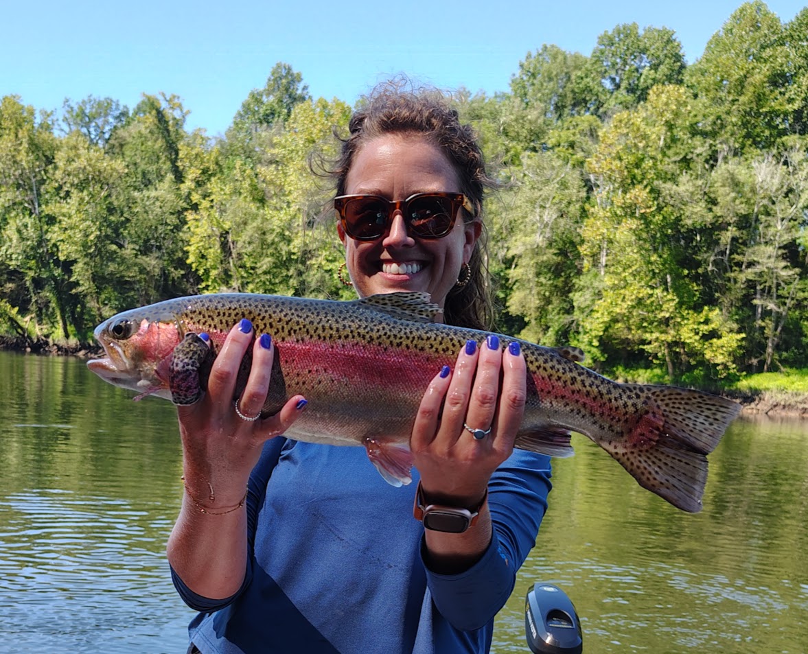 A client proudly holding a vibrant Rainbow Trout caught on a guided fly fishing trip on the Cumberland River.