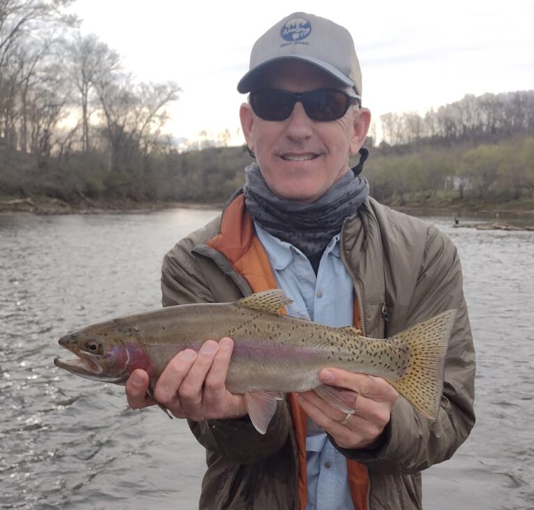 Professional fly fishing guide Captain Jeff Sharpe holding a beautiful Rainbow Trout caught on the Holston River tailwater.