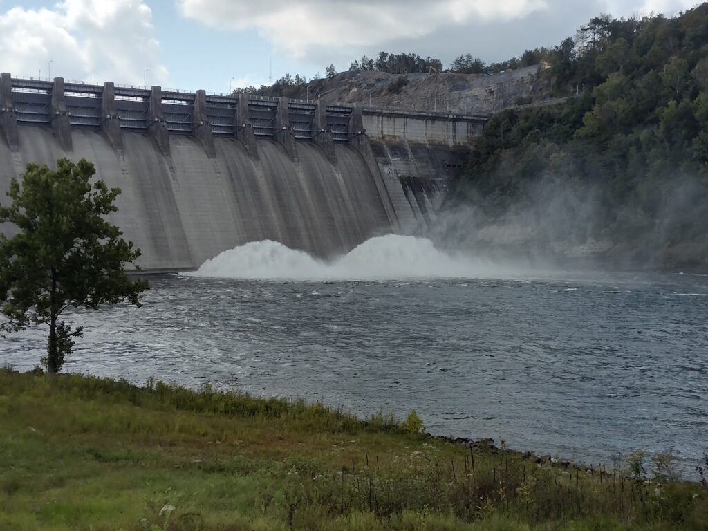 Water rushing through the open sluice gates of Wolf Creek Dam on the Cumberland River in Kentucky.