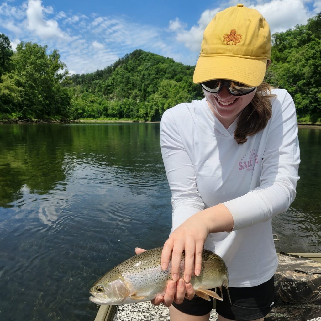 A healthy Cumberland River Rainbow Trout being held by a young lady.