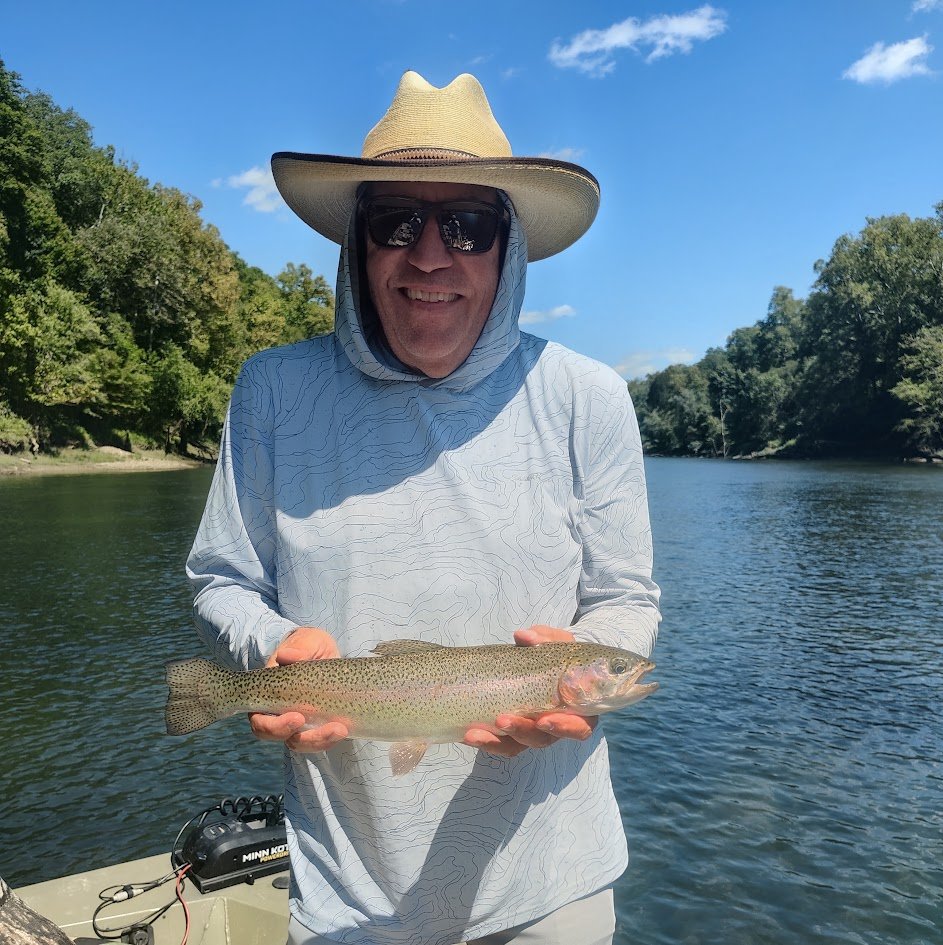 Angler holding a beautiful rainbow trout caught on a jet boat on the Cumberland River in Burkesville, Kentucky