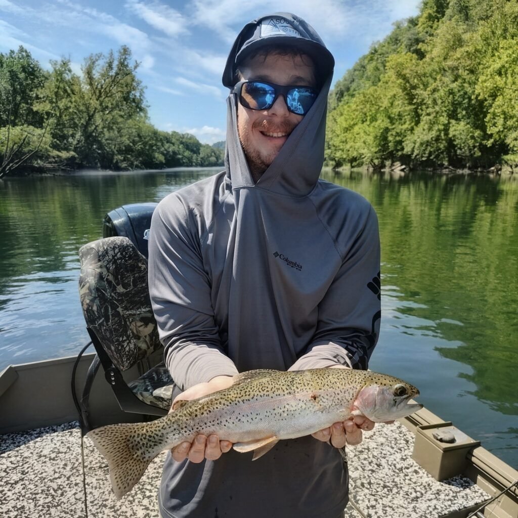 Angler holding a quality rainbow trout on a guided fly fishing trip on the Cumberland River in Burkesville, Kentucky