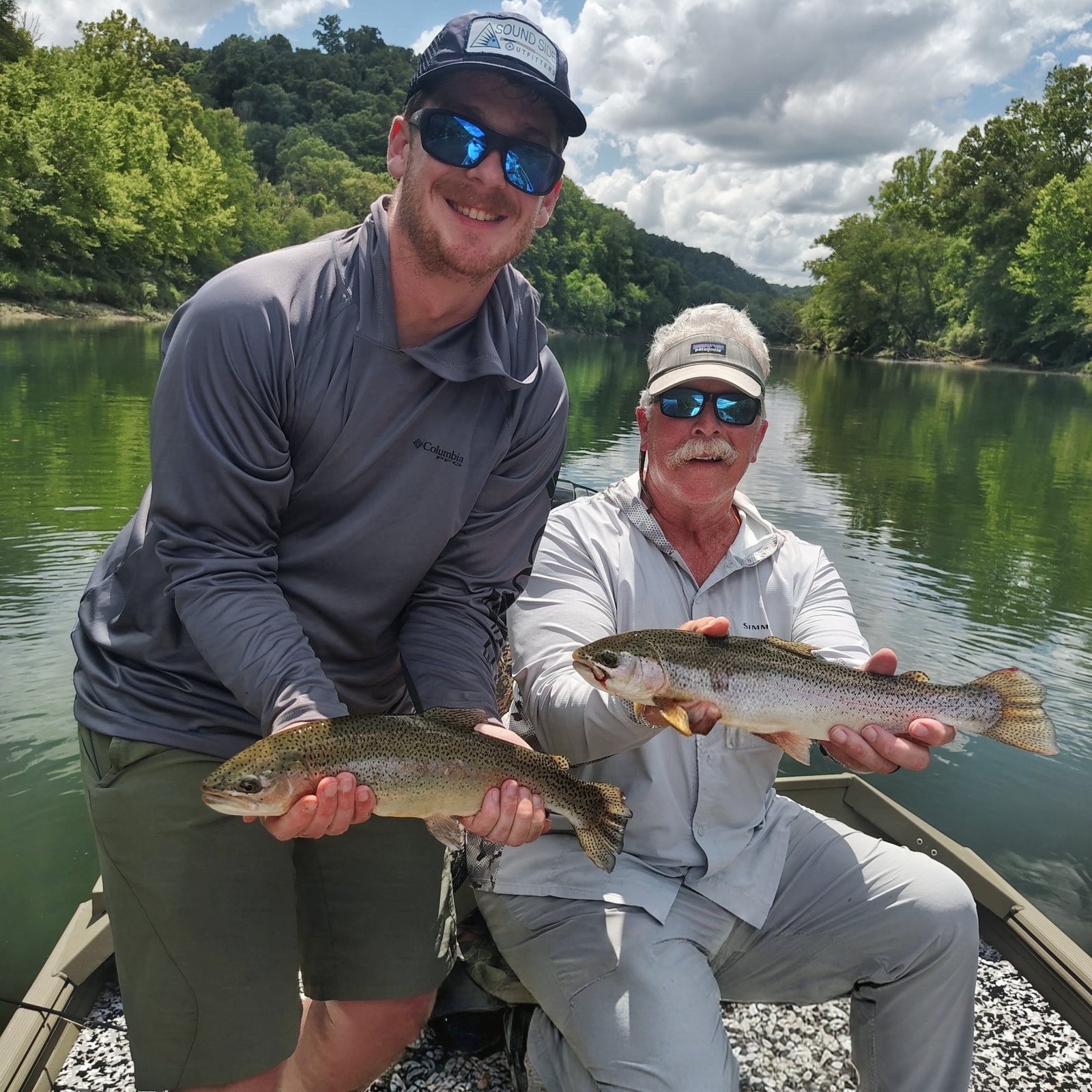 Two clients holding quality trout together on a guided fly fishing trip on the Cumberland River in Burkesville, Kentucky