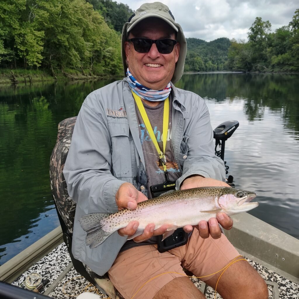 A smiling client on the Cumberland River with a Rainbow Trout
