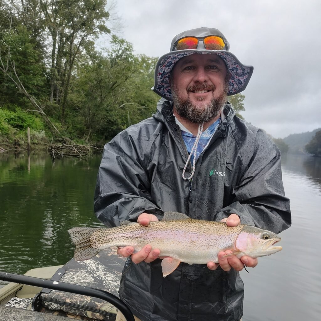 Angler holding a healthy rainbow trout on a guided fly fishing trip on the Cumberland River in Burkesville, Kentucky