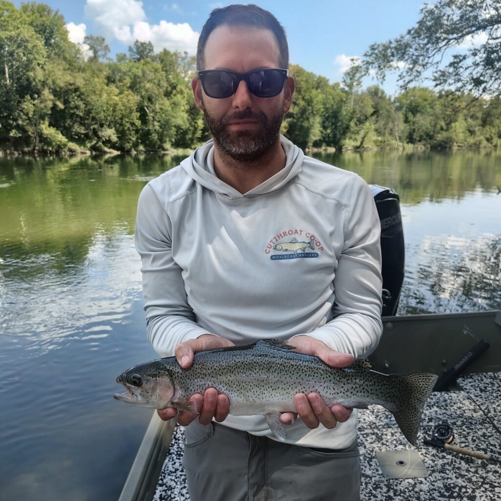 A happy client with a hopper eating Rainbow Trout