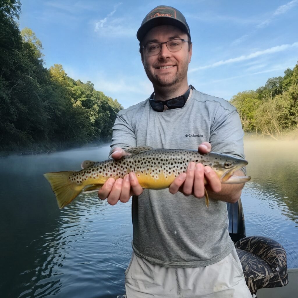 A Brown Trout caught on a Hopper being held