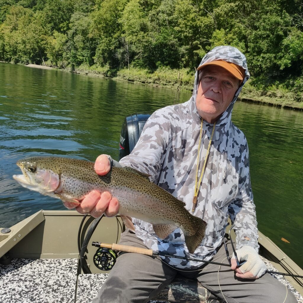 An angler holding a slot-limit fish on a guided fly fishing trip on the Cumberland River in Burkesville, Kentucky.