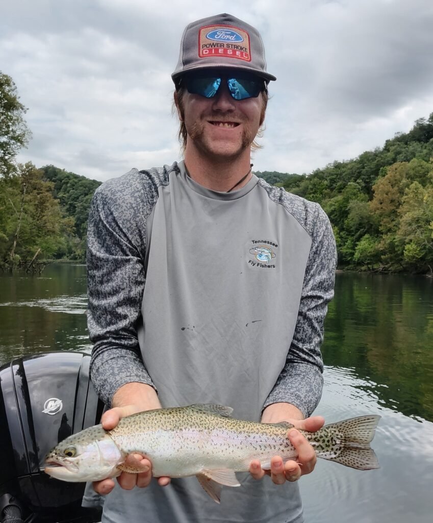 Angler holding a quality slot rainbow trout caught on a guided fly fishing trip on the Cumberland River near Burkesville, Kentucky