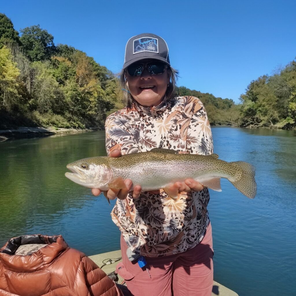 A stunning fall scene on the Cumberland River in Burkesville, Kentucky, featuring a healthy rainbow trout and gorgeous autumn colors along the riverbank.