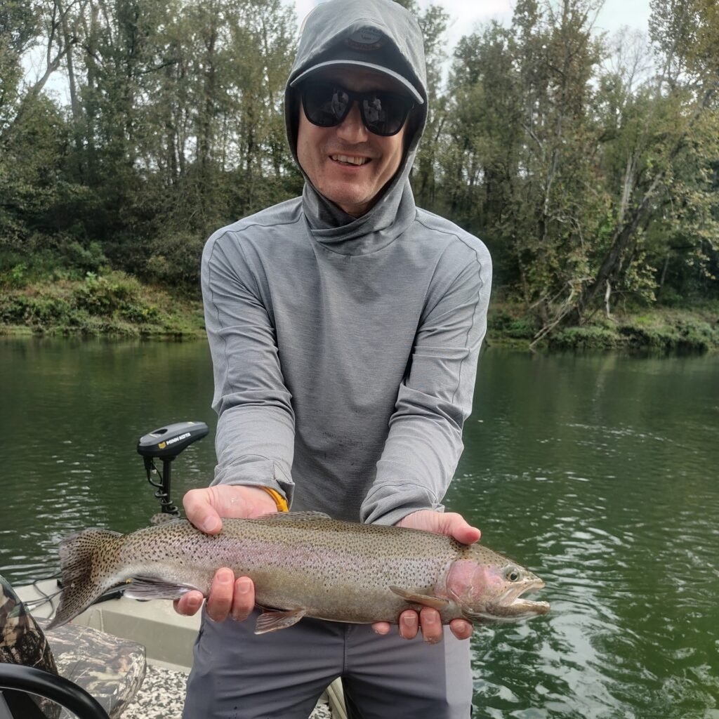 Angler holding a quality rainbow trout during a guided fly fishing trip on the Cumberland River in Burkesville, Kentucky.