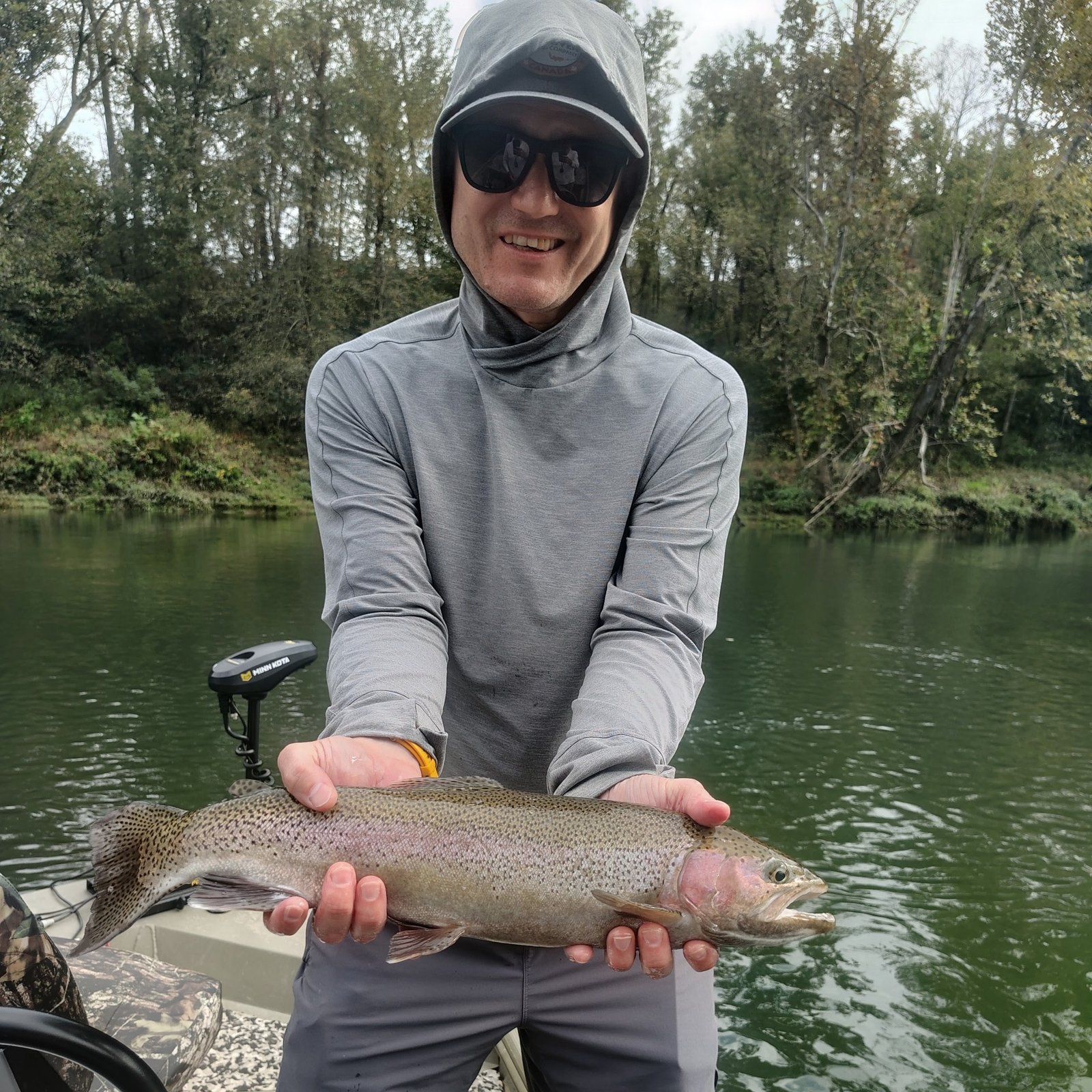 Angler holding a quality rainbow trout during a guided fly fishing trip on the Cumberland River in Burkesville, Kentucky.